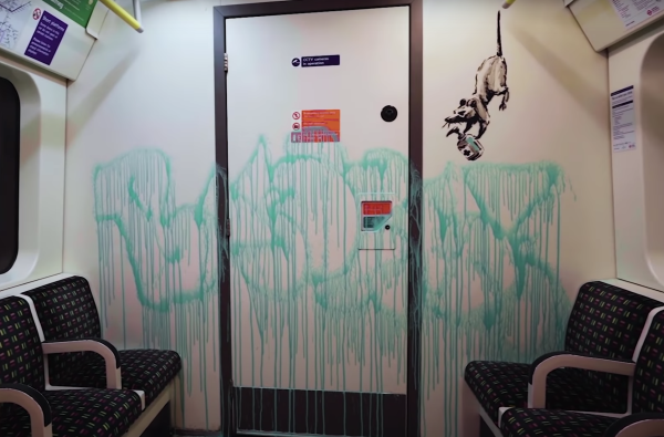 Banksy tags the London Tube with masked-themed graffiti
