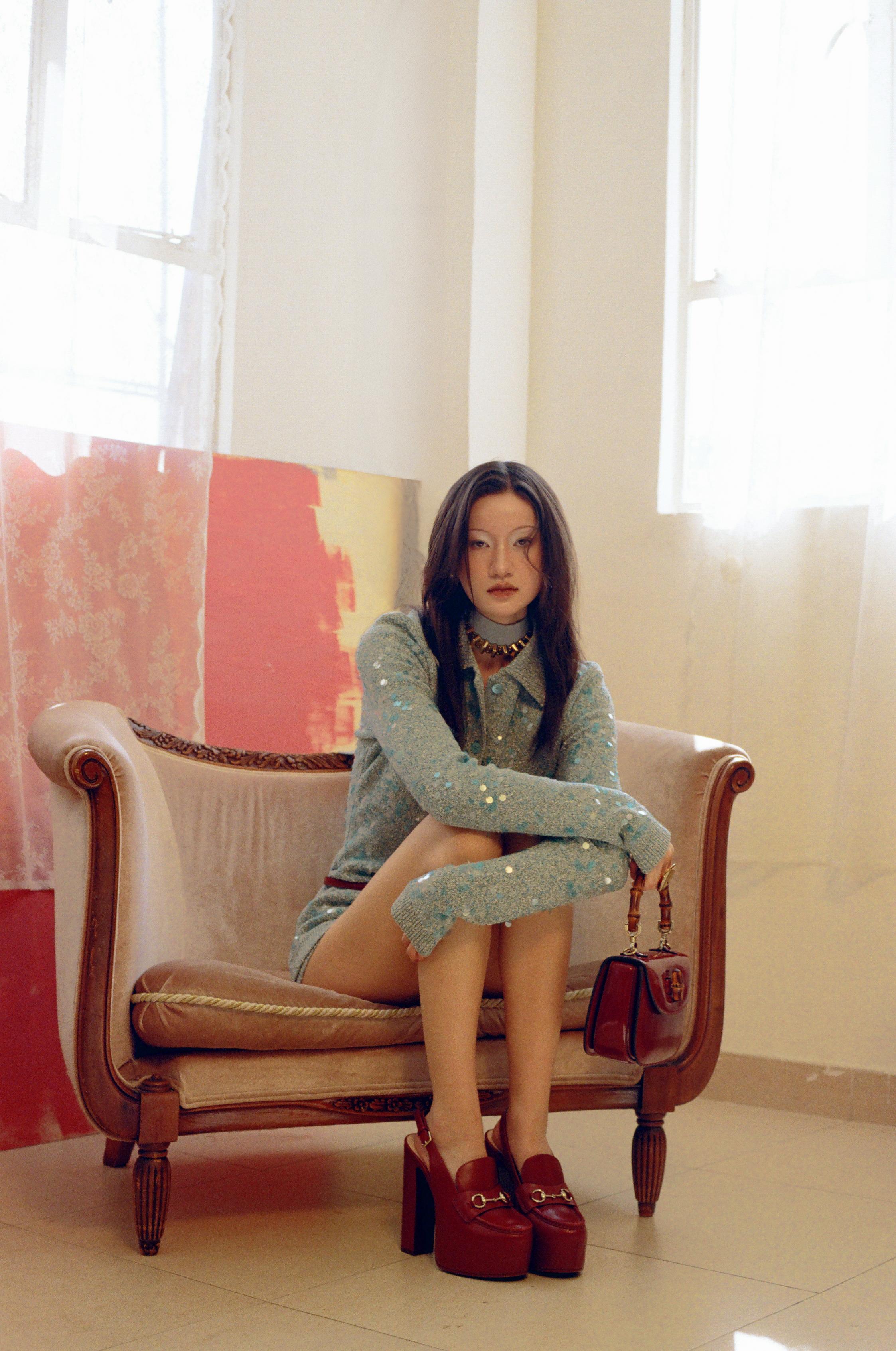 Turquoise sequined polo cardigan and shorts; red leather bag, platform loafer slingbacks and belt; crepe ribbon and choker _ Gucci; Gold ring _ Celine