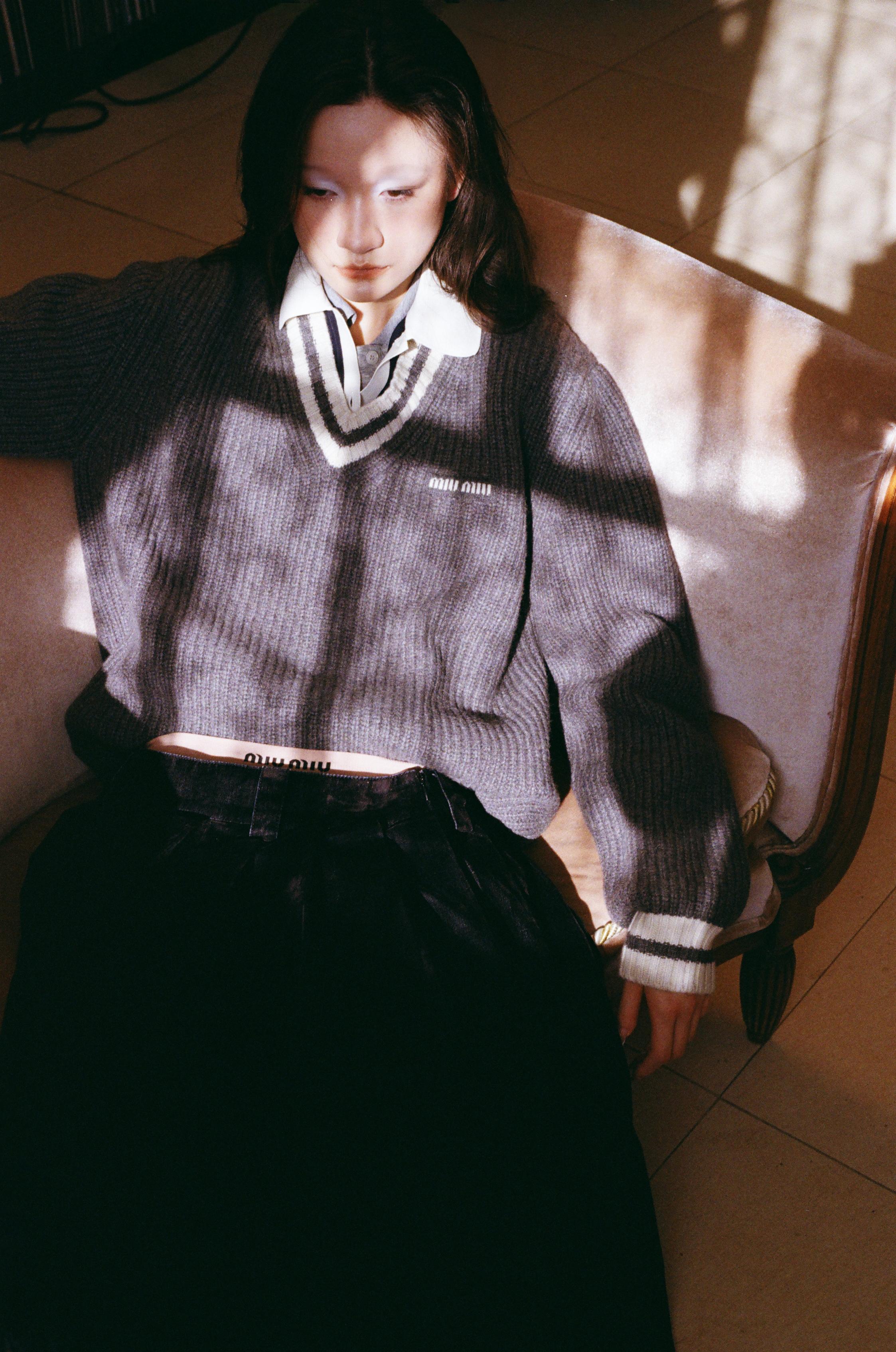 Grey V-neck sweater and knit polo shirt, and black skirt and underwear _ Miu Miu