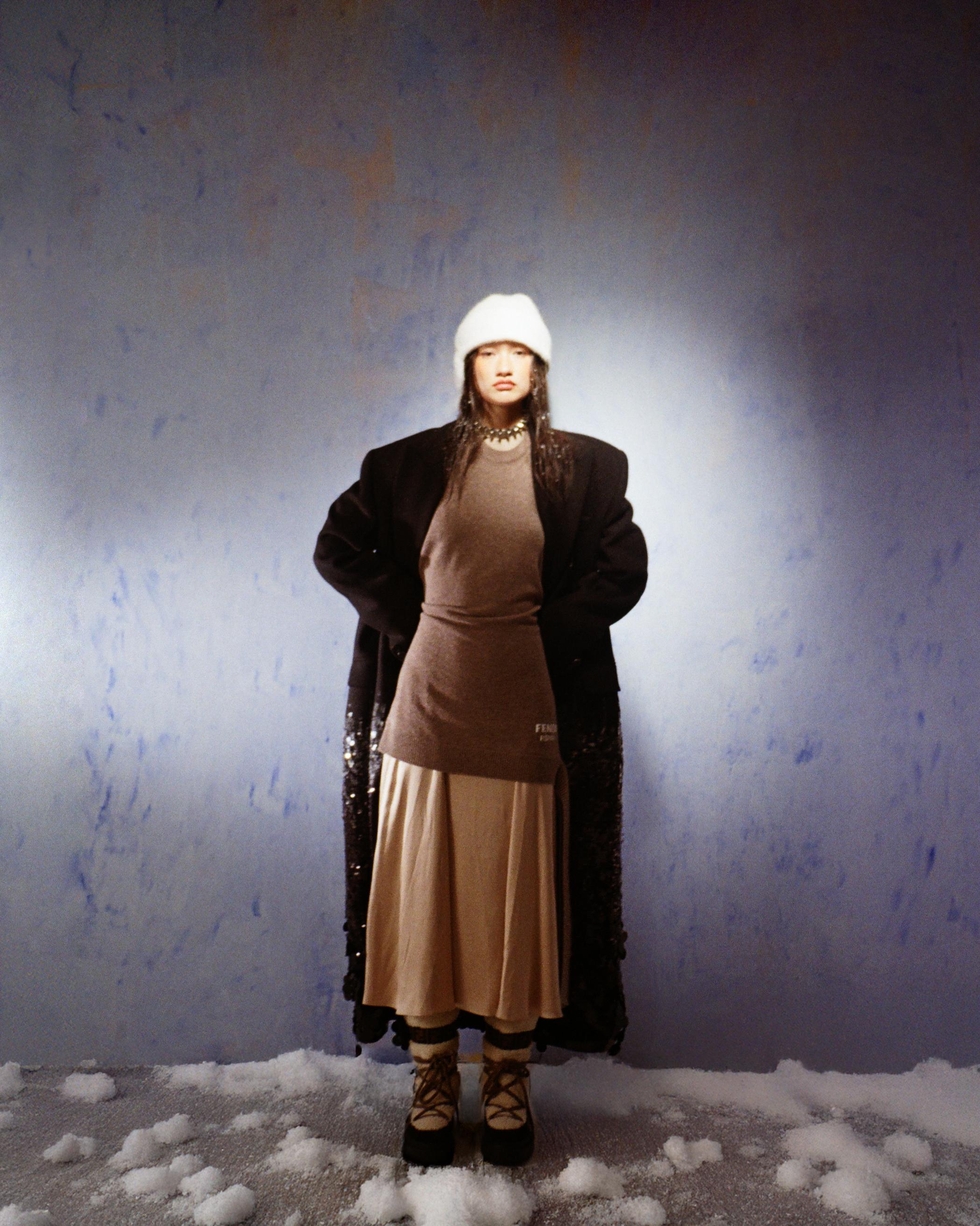 Beige dress, skirt and lace- up boots _ Fendi; Black coat and choker _ Gucci