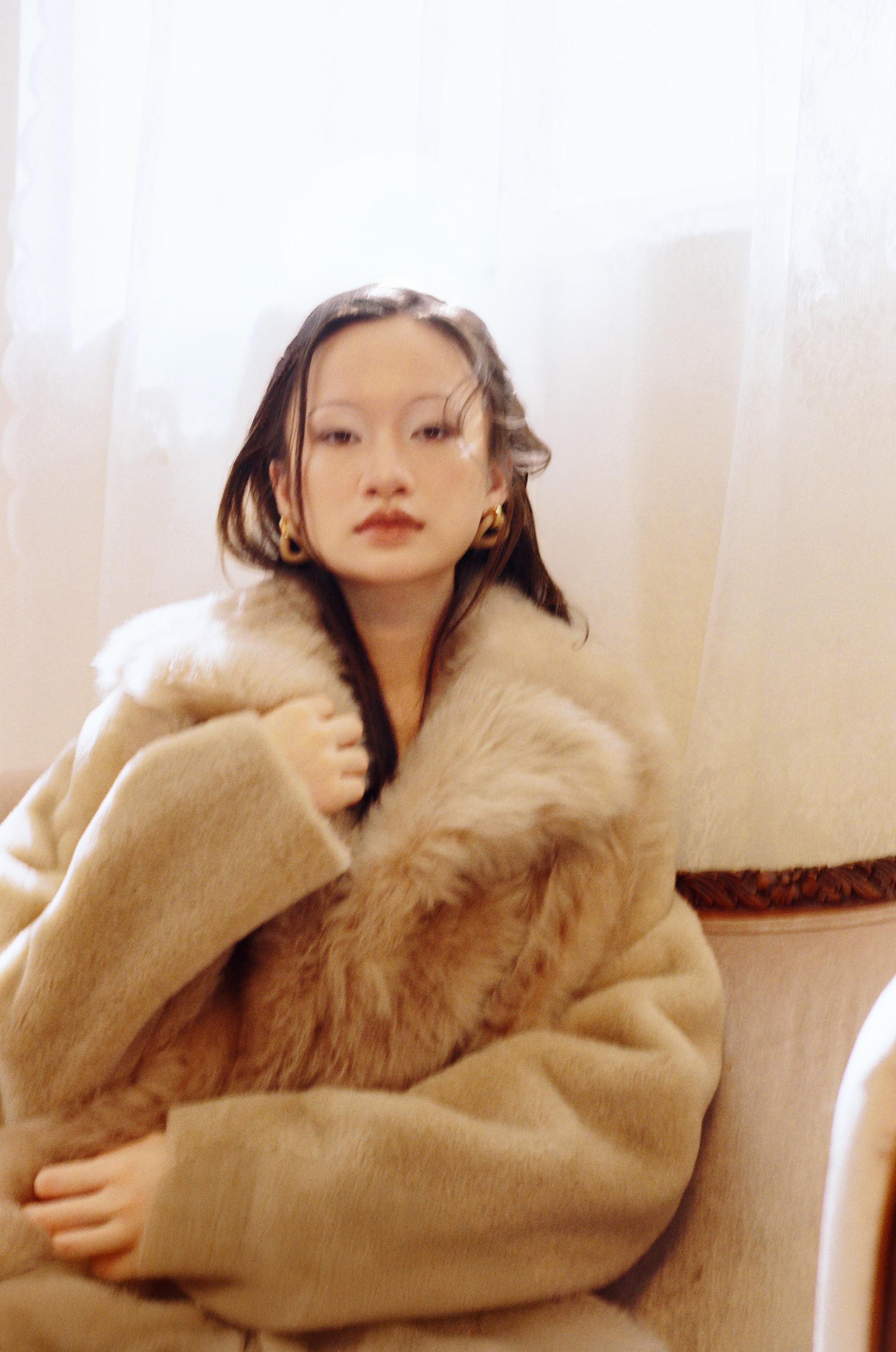 Fur coat and gold earrings _ Fendi