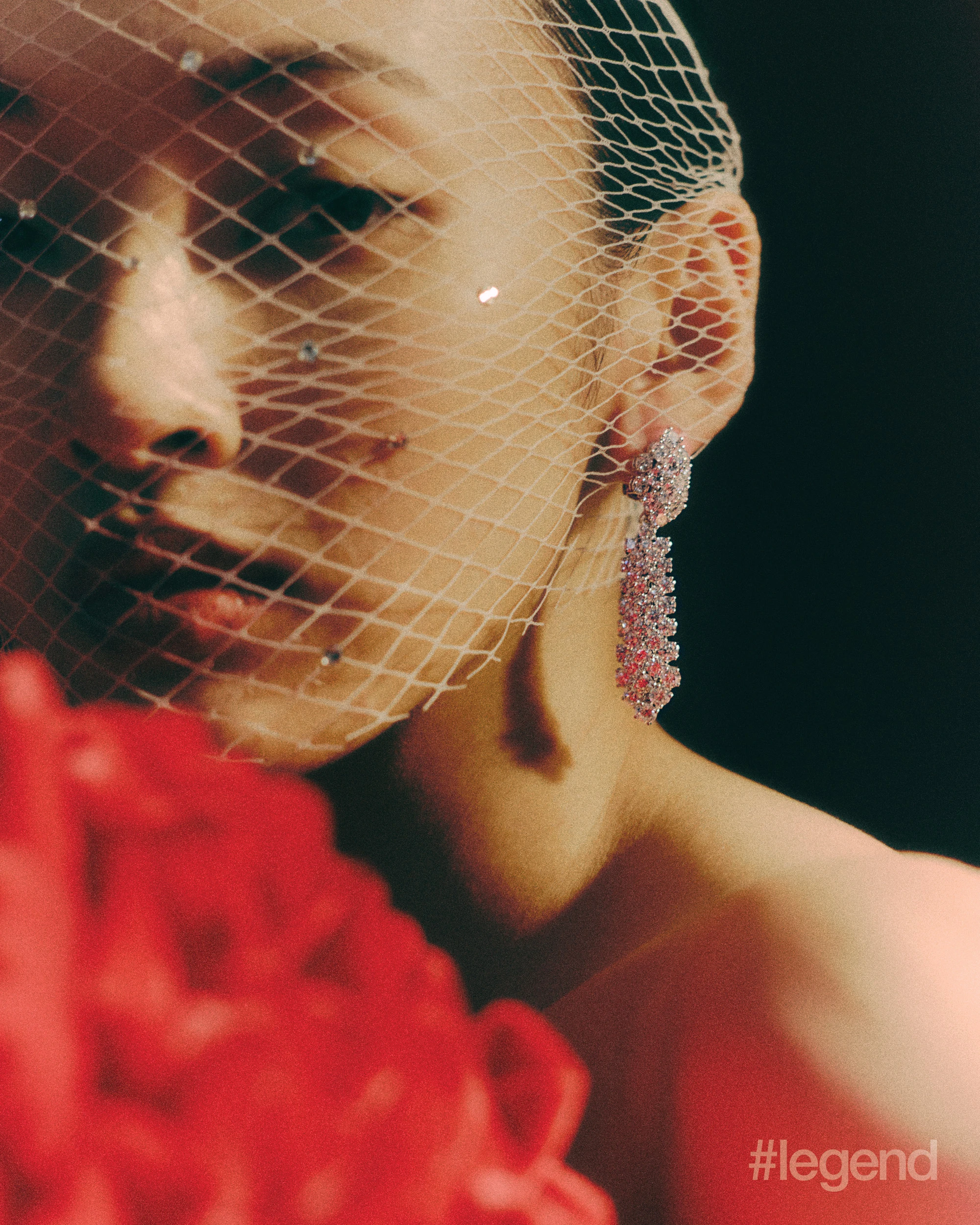 À Cheval earrings in platinum with diamonds and Ludo bracelet in 18k white gold with diamonds and onyx _ Van Cleef & Arpels; Red dress _ Chen Peng; Black leather pumps _ Prada (Stylist’s own gloves).