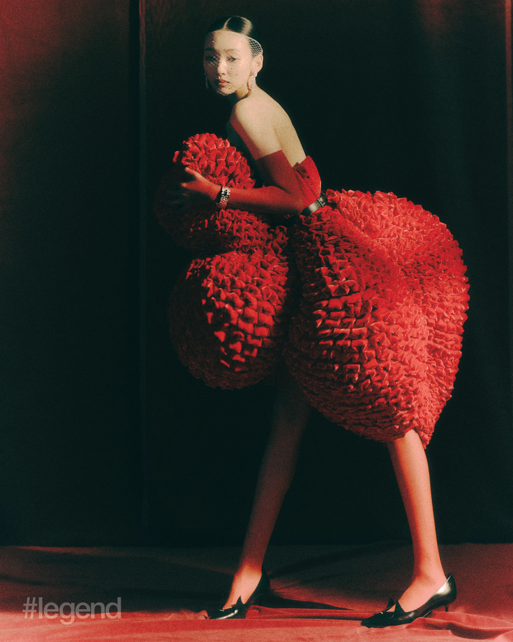 À Cheval earrings in platinum with diamonds and Ludo bracelet in 18k white gold with diamonds and onyx _ Van Cleef & Arpels; Red dress _ Chen Peng; Black leather pumps _ Prada (Stylist’s own gloves).