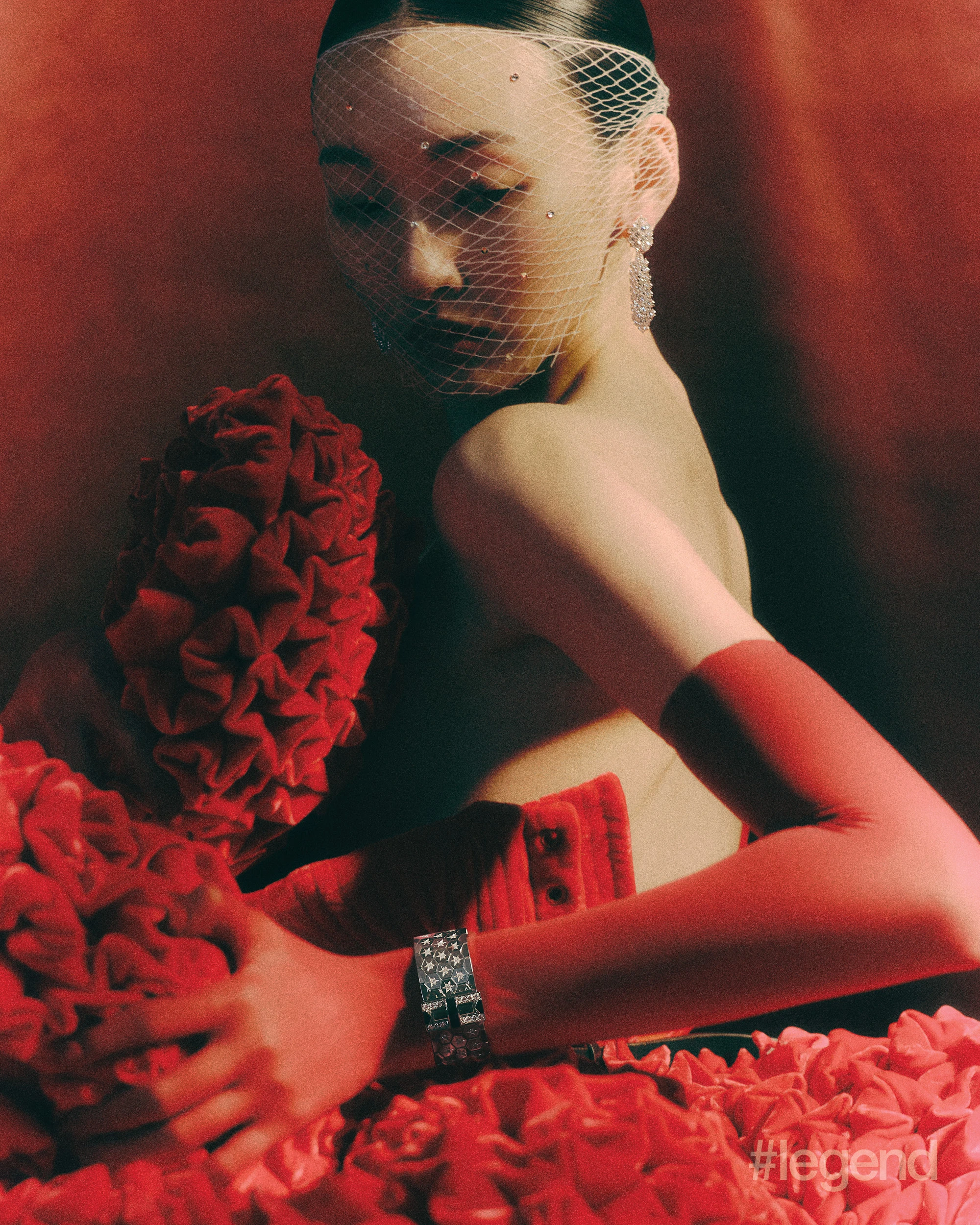 À Cheval earrings in platinum with diamonds and Ludo bracelet in 18k white gold with diamonds and onyx _ Van Cleef & Arpels; Red dress _ Chen Peng; Black leather pumps _ Prada (Stylist’s own gloves).