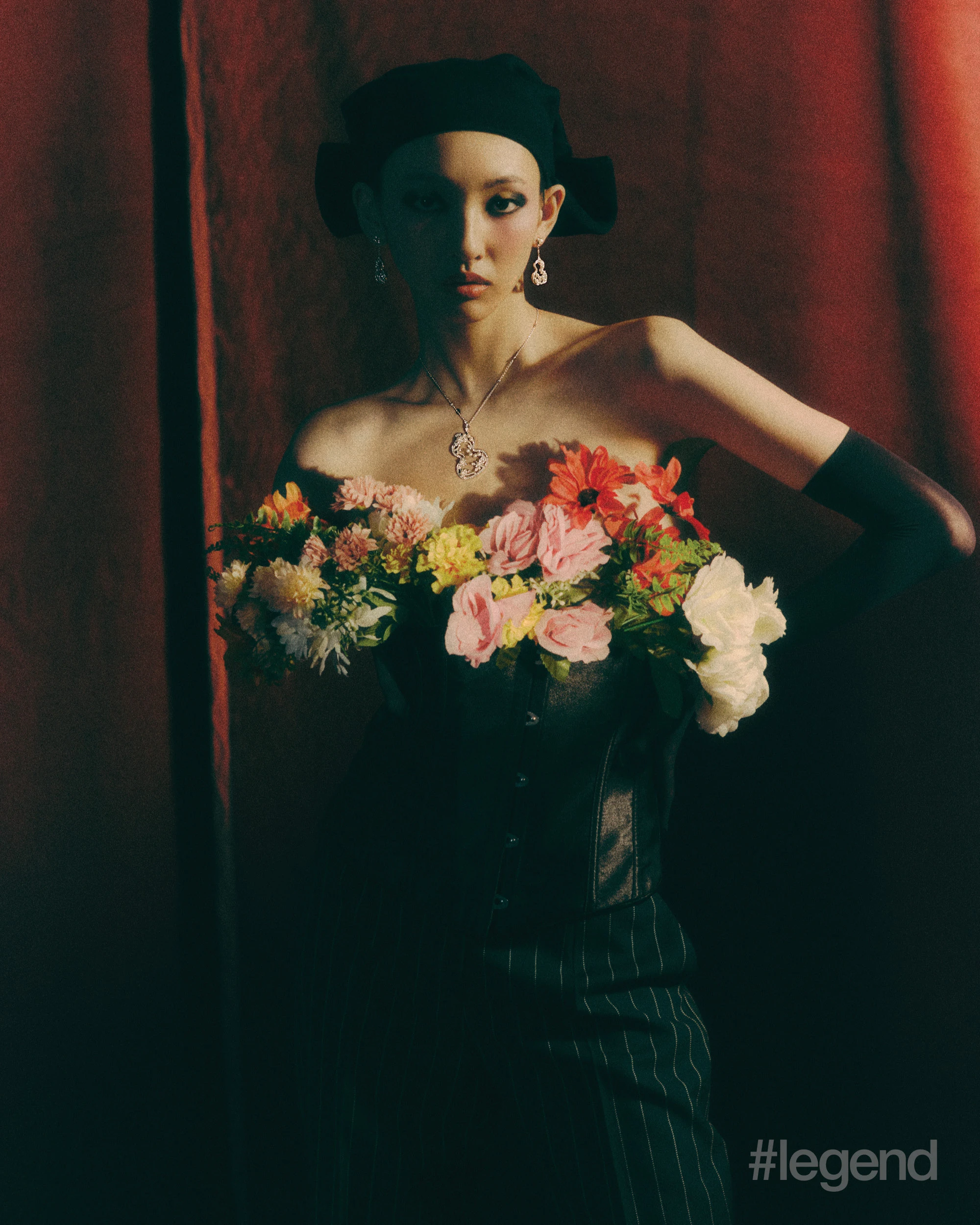 Wulu Garden earrings and necklace in 18k white gold with pearls _ Qeelin; Black striped trousers _ Dolce&Gabbana; Black silk turban _ Loro Piana (Stylist’s own corset and gloves).