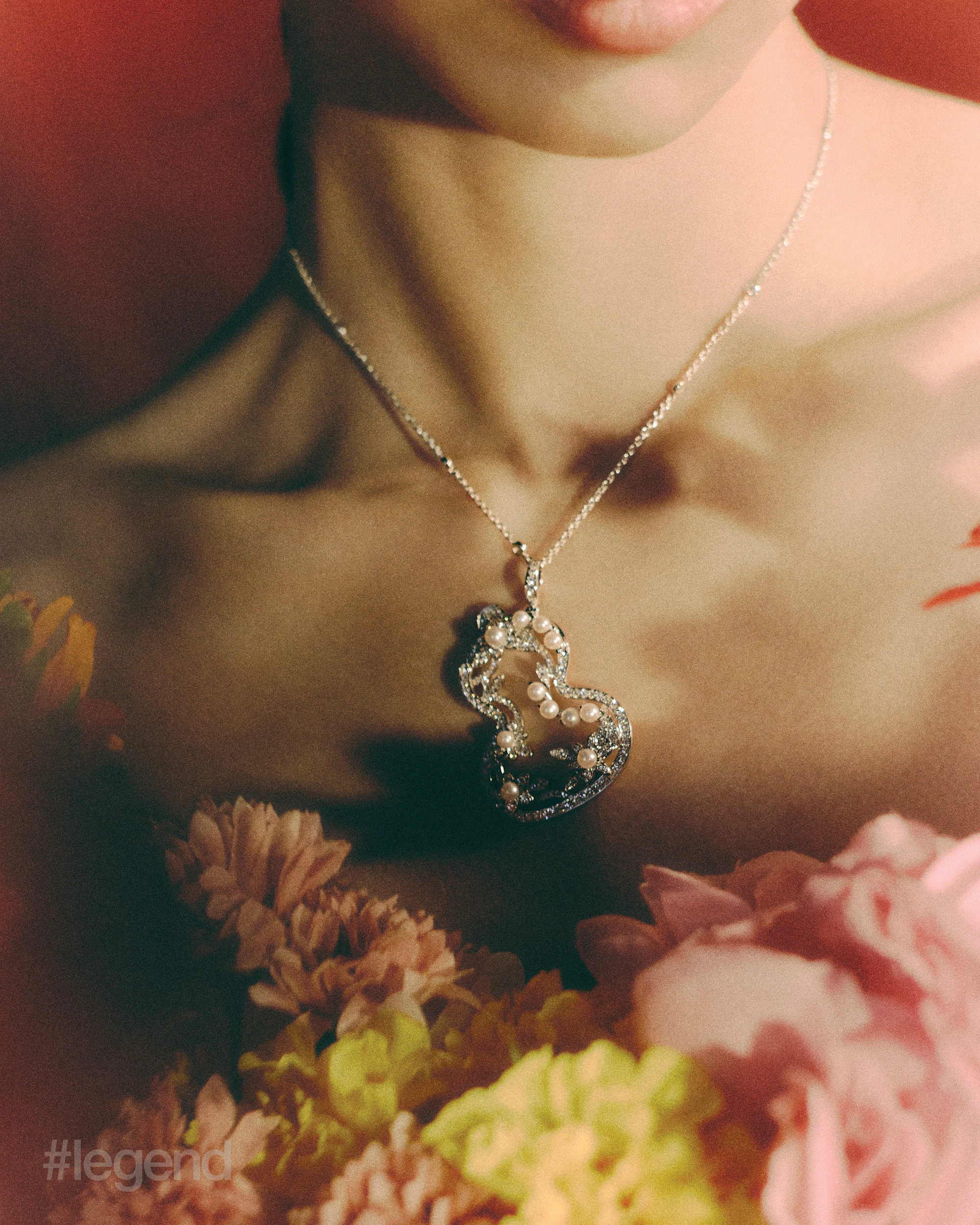 Wulu Garden earrings and necklace in 18k white gold with pearls _ Qeelin; Black striped trousers _ Dolce&Gabbana; Black silk turban _ Loro Piana (Stylist’s own corset and gloves).