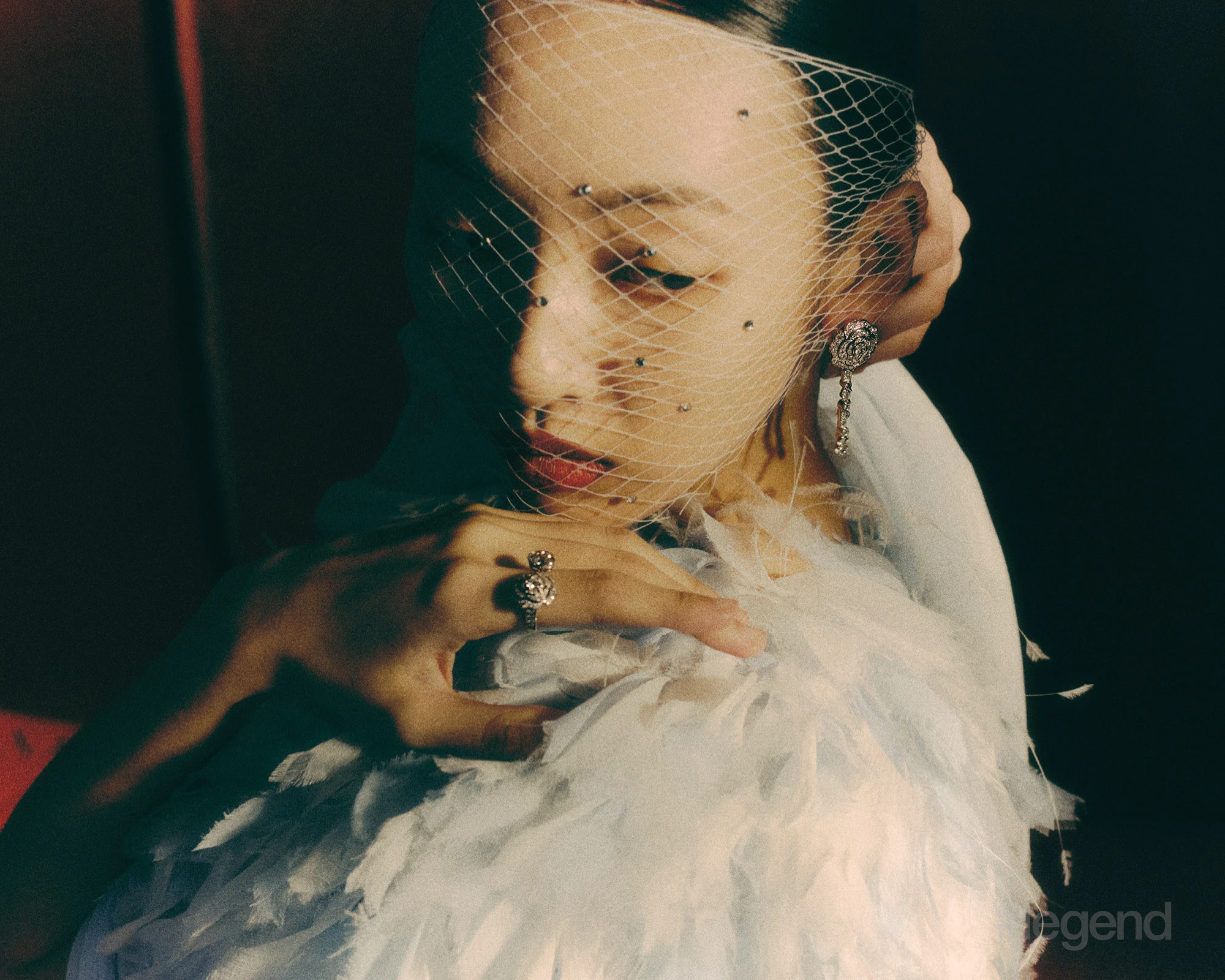 Camélia Diamant Evanescent earrings and ring in 18k white gold with diamonds _ Chanel; Light blue feathered cape_ Chanel.