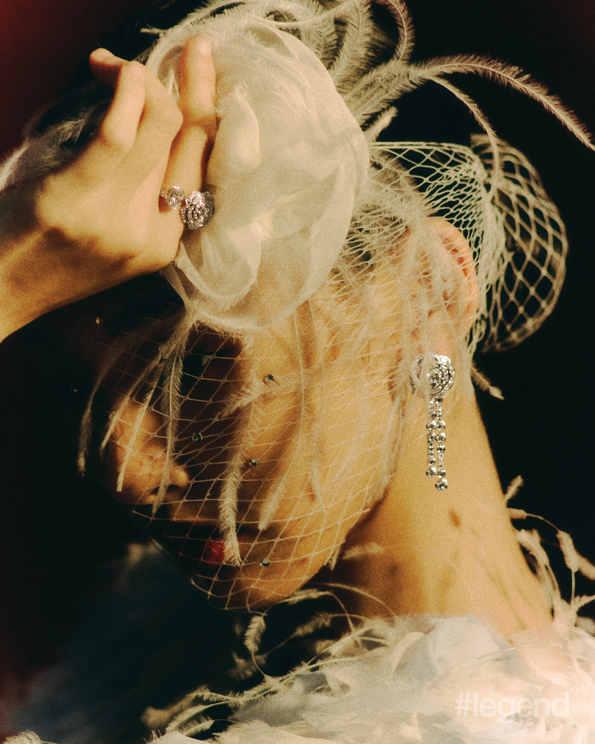 Camélia Diamant Evanescent earrings and ring in 18k white gold with diamonds _ Chanel; Light blue feathered cape_ Chanel.