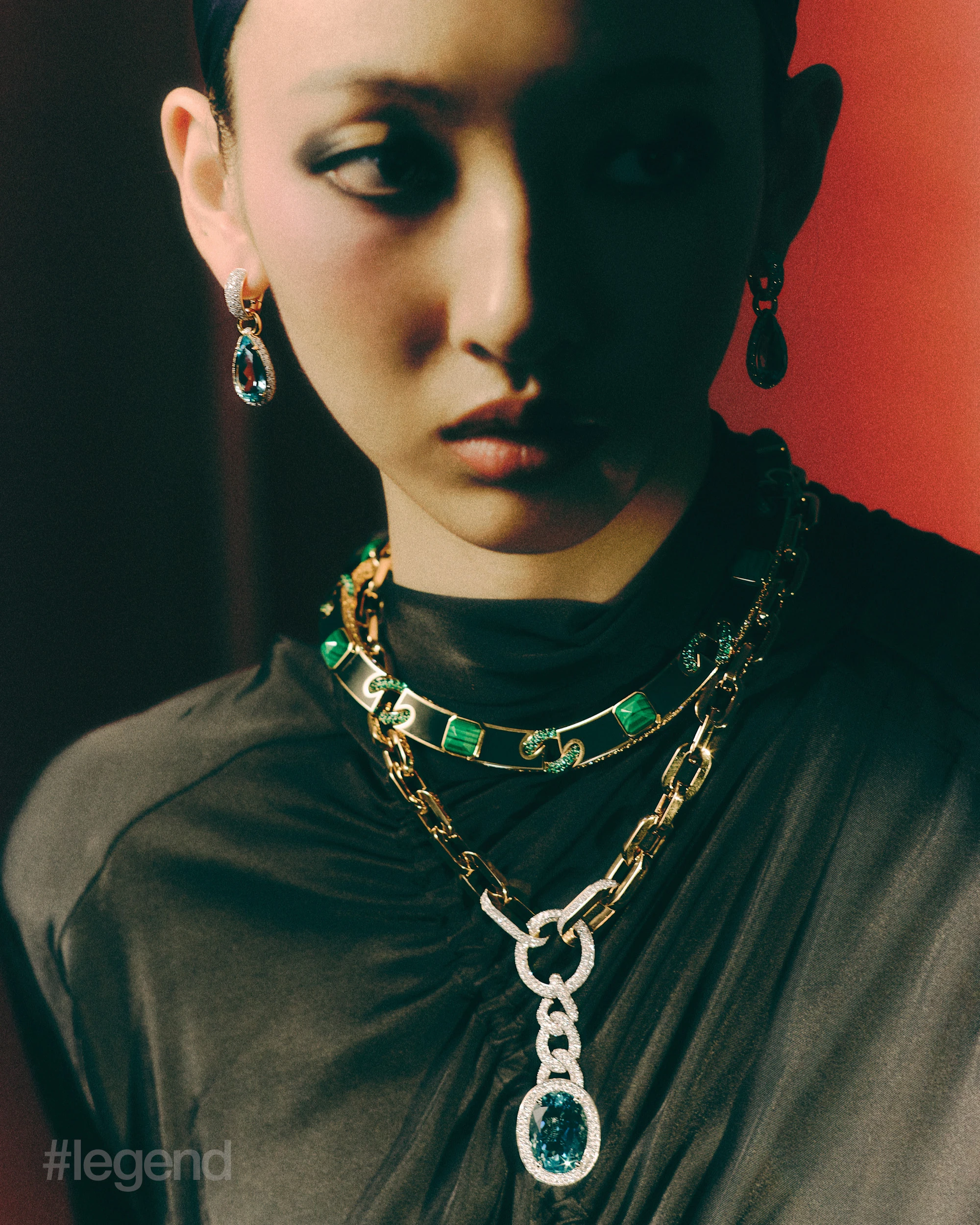 Dualism of Milan earrings with aquamarine, and Ode to Milan necklace with aquamarine and choker _ Pomellato; Black dress with gathered detail _ Ferragamo.