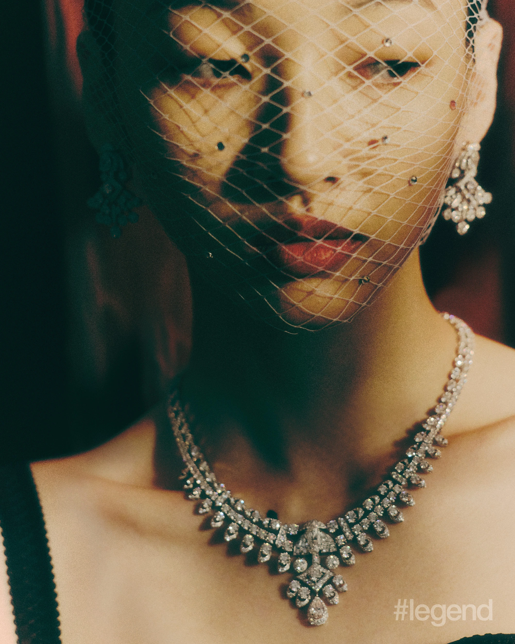 Tribal Collection earrings and necklace with diamonds _ Graff; Black pointed bra top _ Dolce&Gabbana.