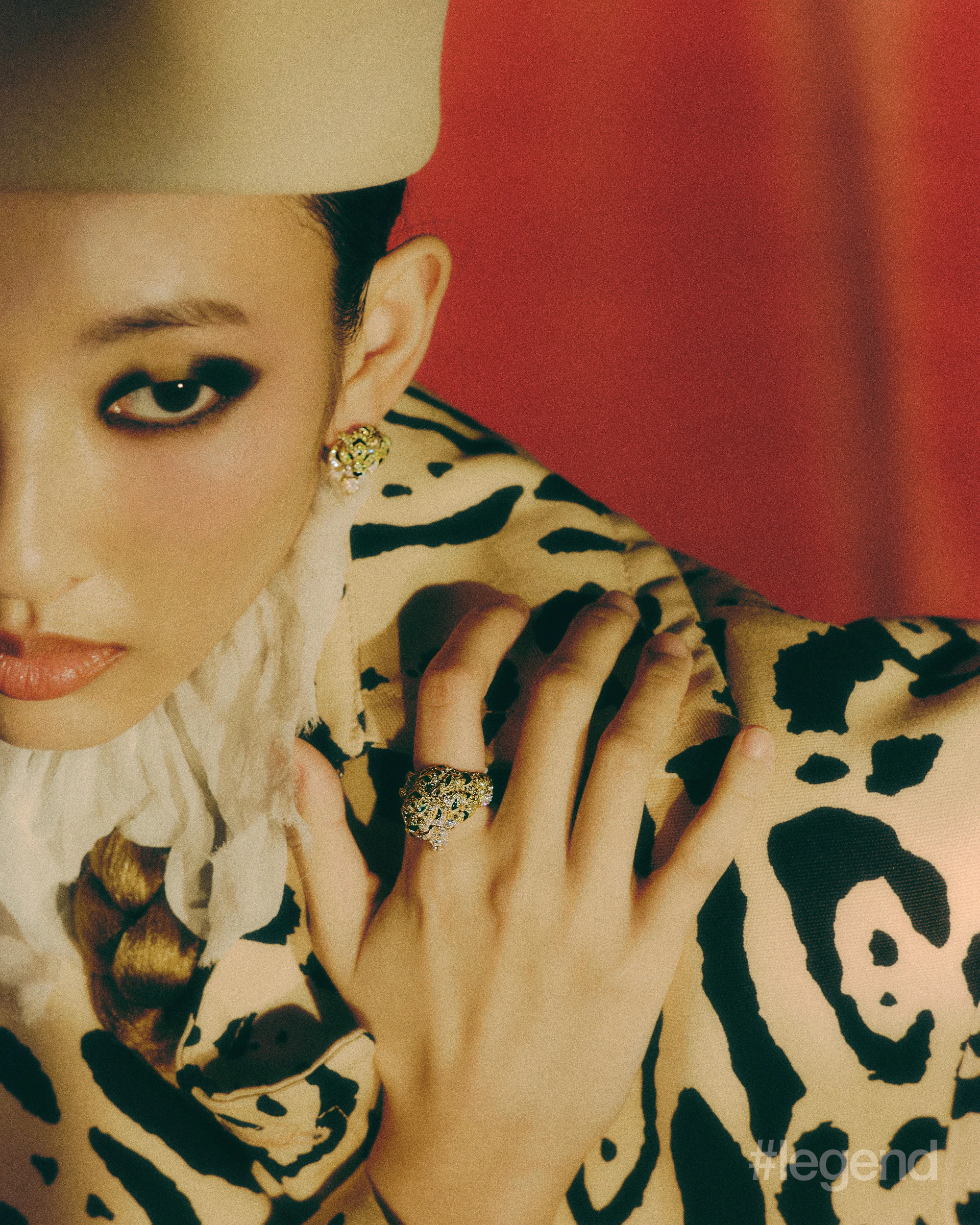 Panthère de Cartier earrings and ring _ Cartier; Ivory fringed collar blouse _ McQueen; Beige animal-print trench coat _ Sportmax; Beige rabbit fur hat _ Loro Piana (Stylist’s own corset).