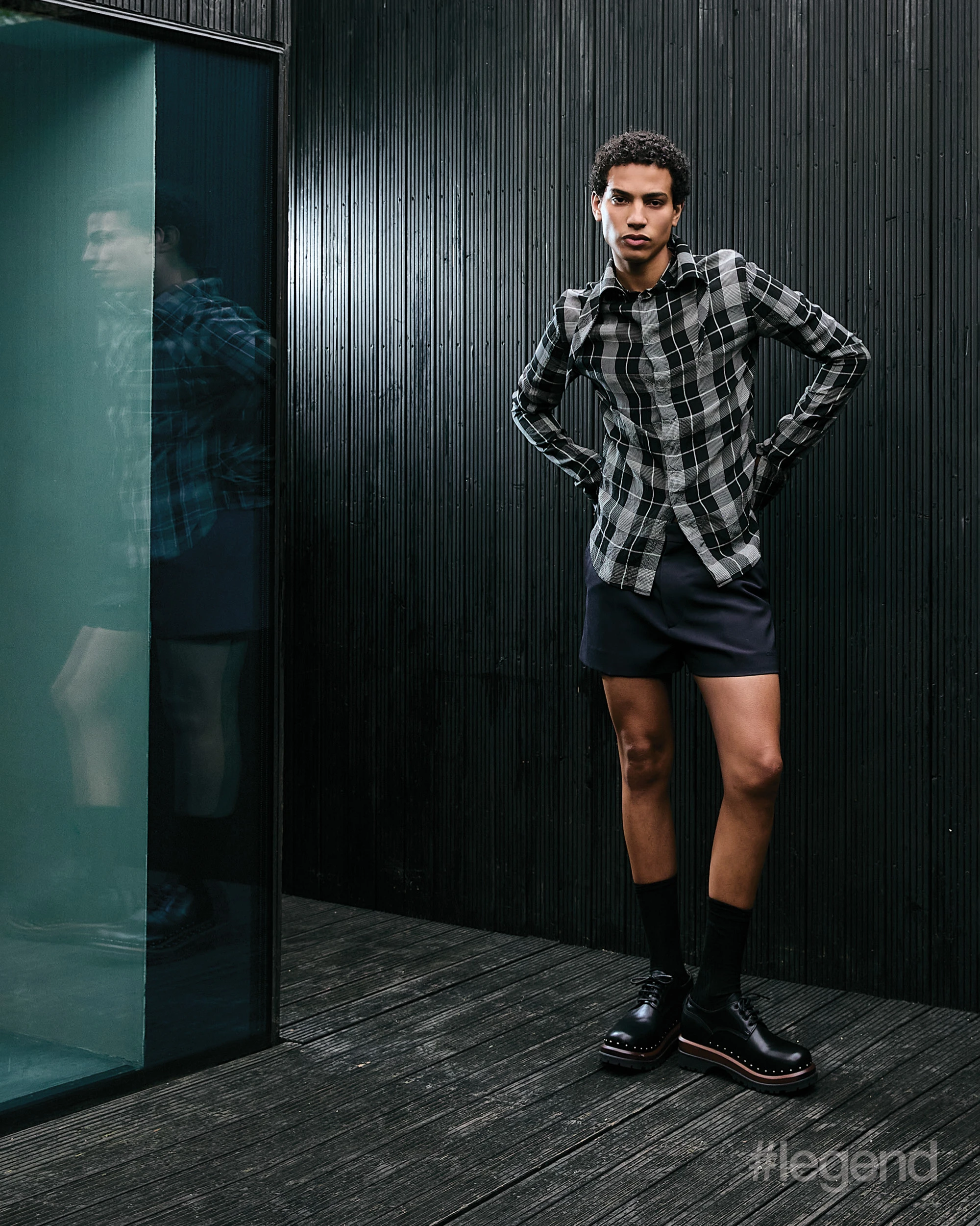 fashion Black and white chequered shirt _ Loewe; Navy shorts _ Gucci; Black shoes _ Dior