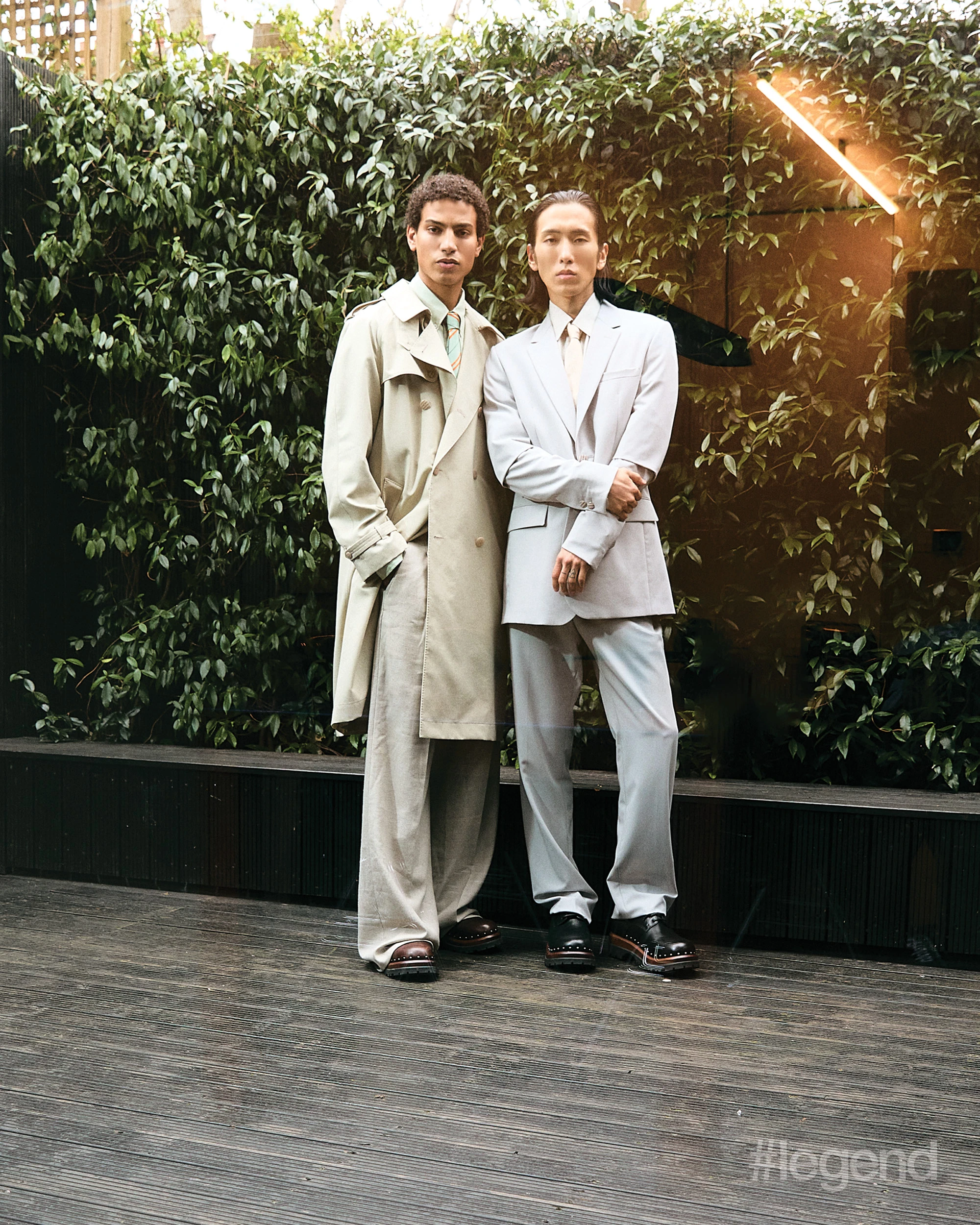 On Adam: Beige coat and trousers, and green shirt and tie _ Fendi; Brown shoes _ Dior; On Hyeok: Blue shirt and black shoes _ Dior; Blue blazer and trousers _ Fendi