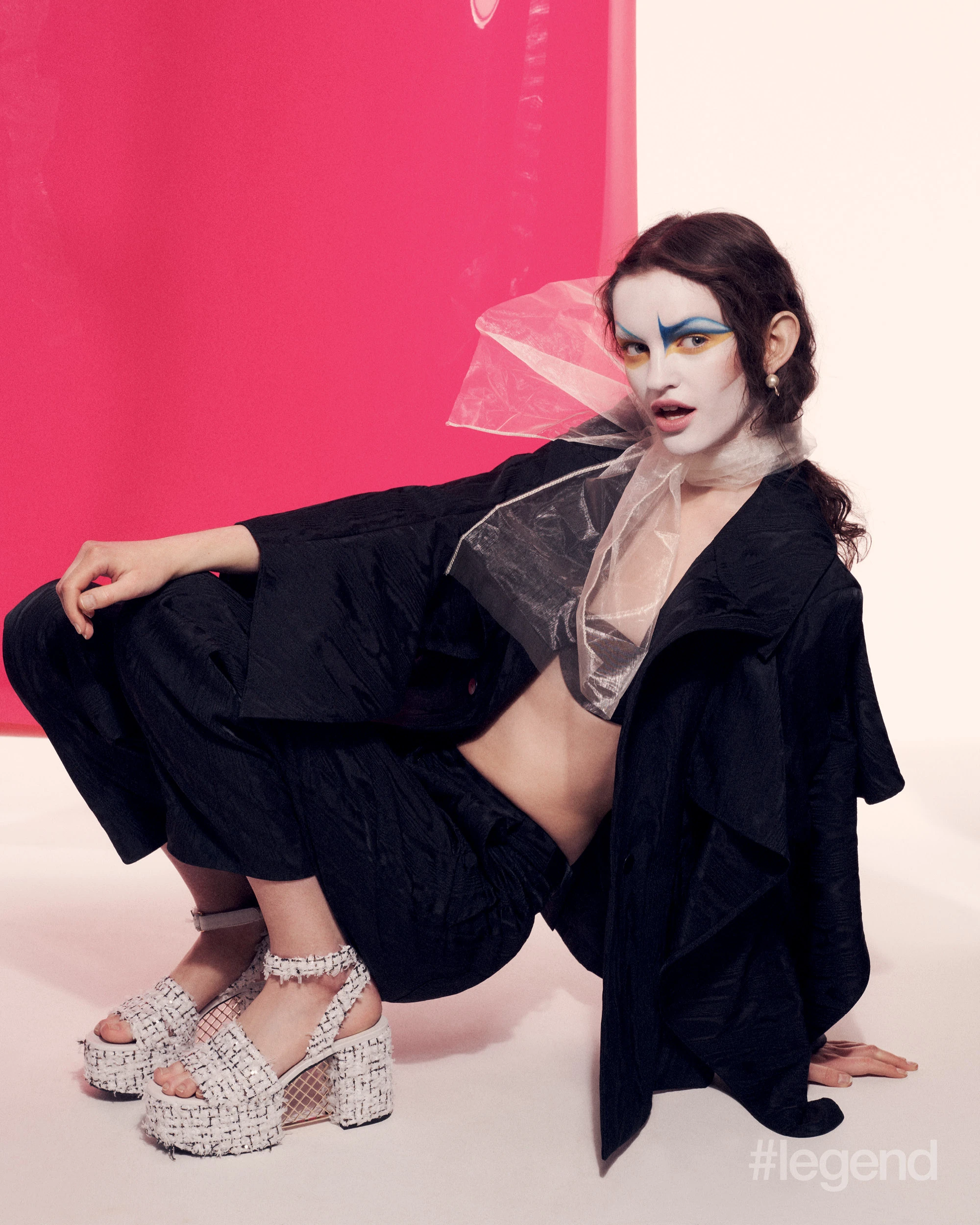 Navy draped-sleeve blazer and trousers _ Palmer Harding; Black bra and pearl earrings _ Dior; White tweed sandals _ Chanel; EyeWear eyeshadow stick in Sunflower, and Satin Kajal Liner in Navy Noir & Electric Blueberry _ Victoria Beckham