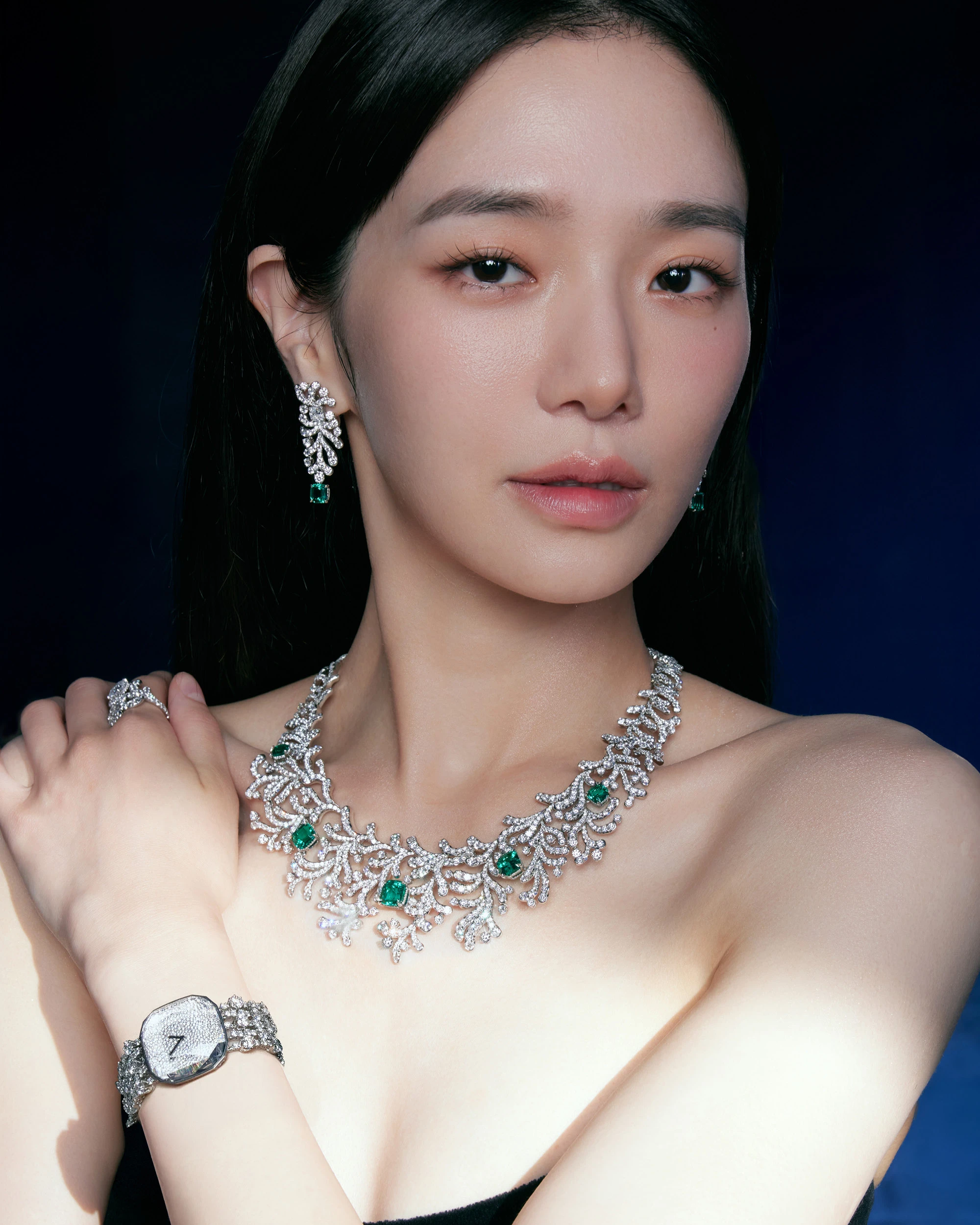 Park wears Ocean Flora earrings and necklace in platinum with emeralds and diamonds, ring in 18k white gold with diamonds, ring in platinum with diamonds, and Carat 128 watch in white gold with diamonds, all by Tiffany & Co.