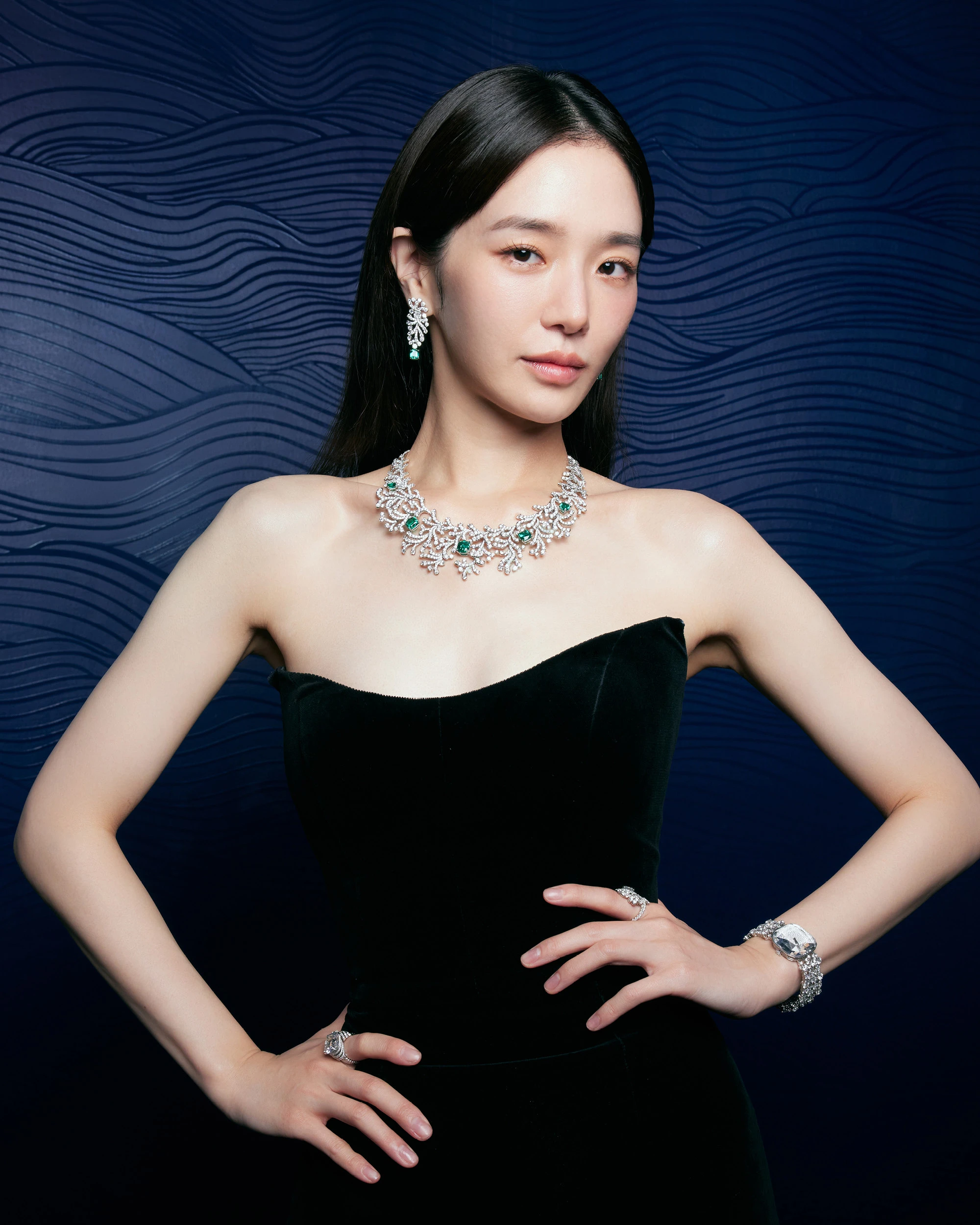 Park wears Ocean Flora earrings and necklace in platinum with emeralds and diamonds, ring in 18k white gold with diamonds, ring in platinum with diamonds, and Carat 128 watch in white gold with diamonds, all by Tiffany & Co.