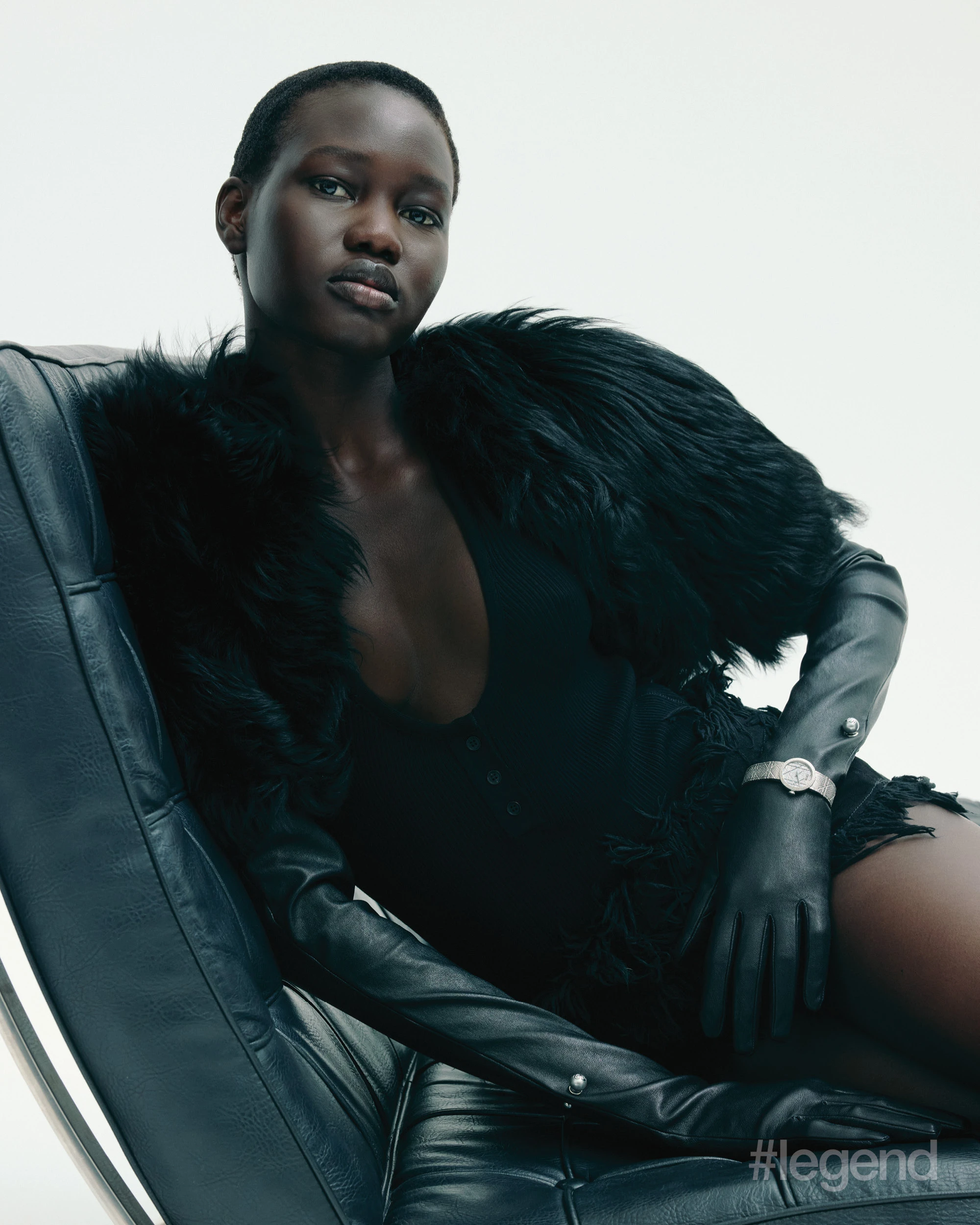 Black top and frayed denim shorts _ Ferragamo; Black feathered gloves and top, and La D My Dior watch _ Dior
