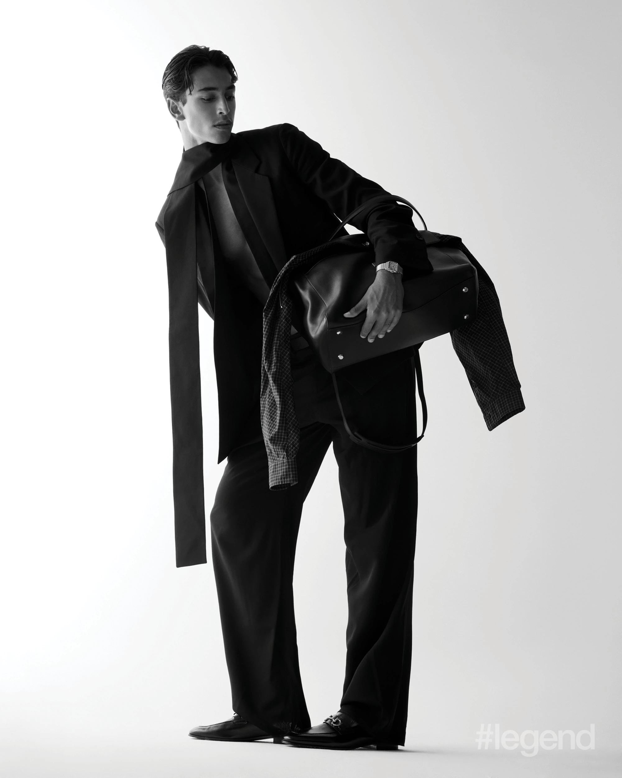 Black blazer, trousers and loafers _ Ferragamo; Black bag _ Balanciaga; Santos de Cartier watch _ Cartier