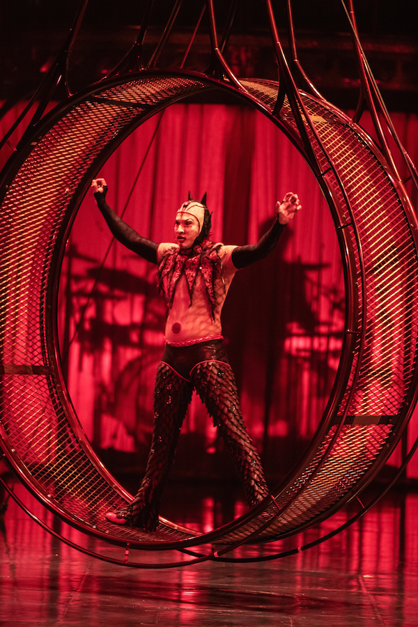 A performer with a devil-inspired costume on the Wheel of Death 