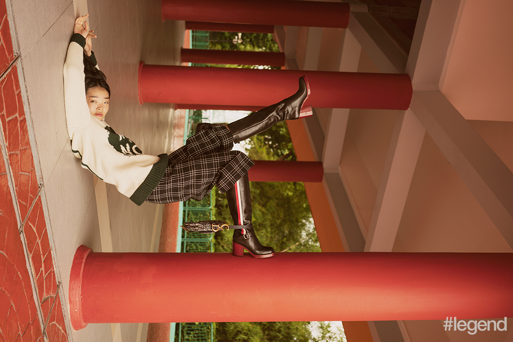 Black-and-green knitted sweater, black-and-white plaid skirt, black striped boots and navy saddle bag_Dior