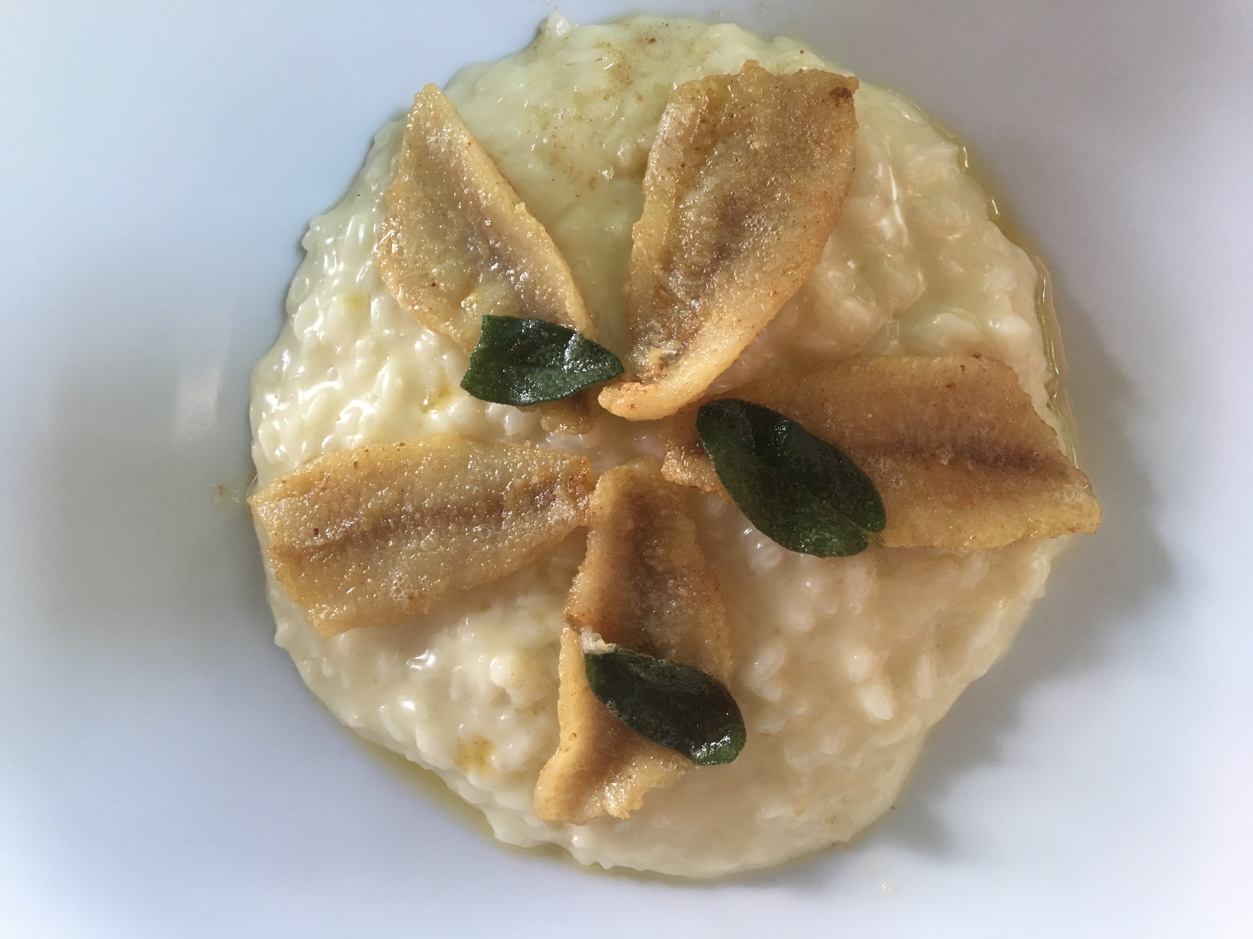 The typical risotto with perch fish from the lake, butter and sage at Gatto Nero