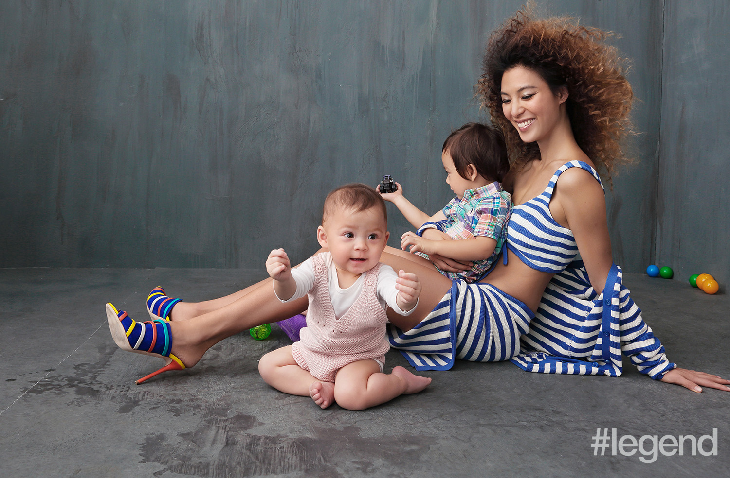 On Alison: skirt, cardigan and bra top by Ralph Lauren, shoes by Malone Souliers and bracelet by Dior; on baby Kaia: knit one-piece and long-sleeved t-shirt by Stella McCartney; on Khalil: Madras one-piece by Ralph Lauren