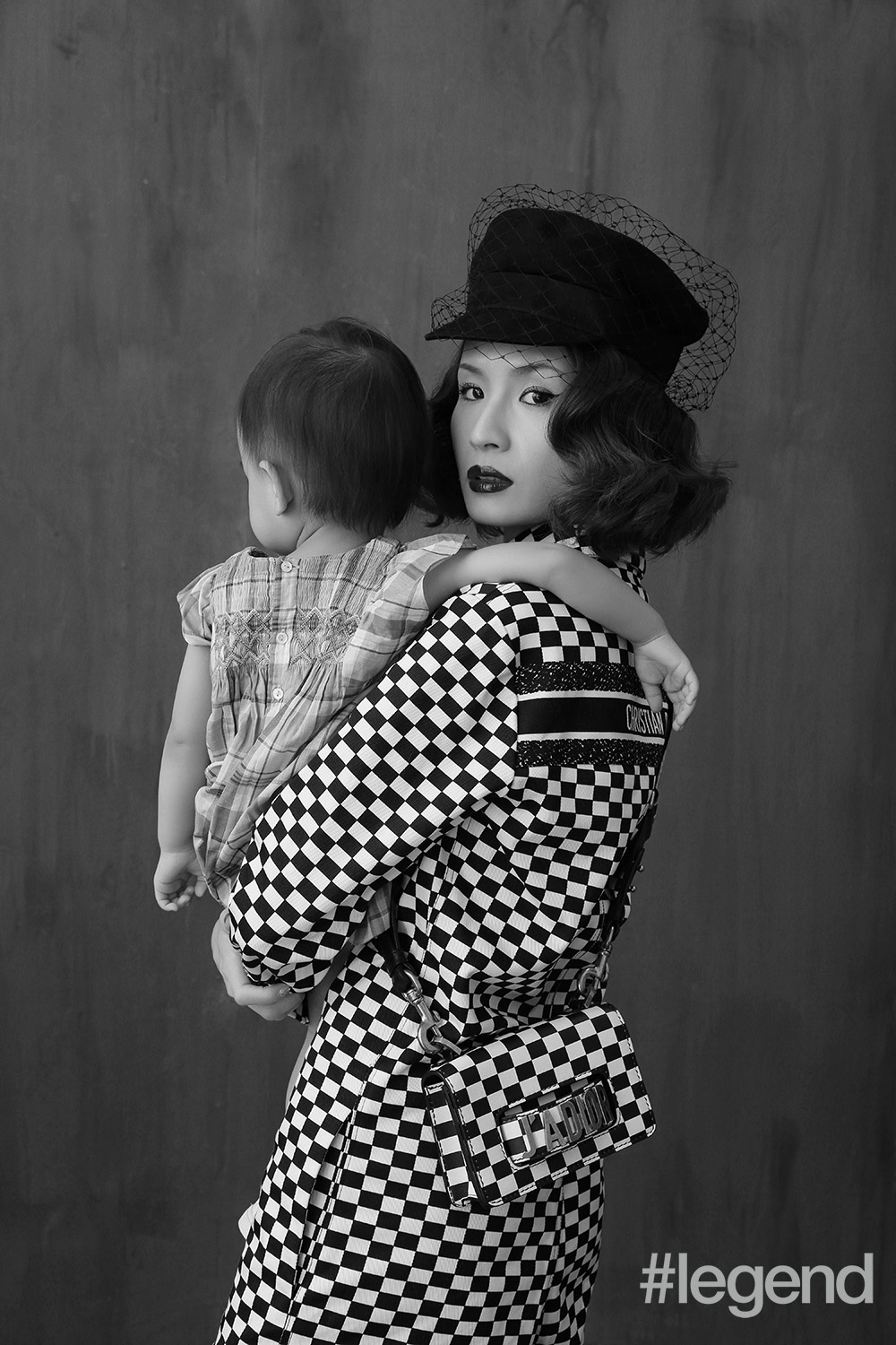On Tracey: jumpsuit, hat, shoes and bag by Dior; On Tilda: Dress by Bonpoint and shoes by Adidas