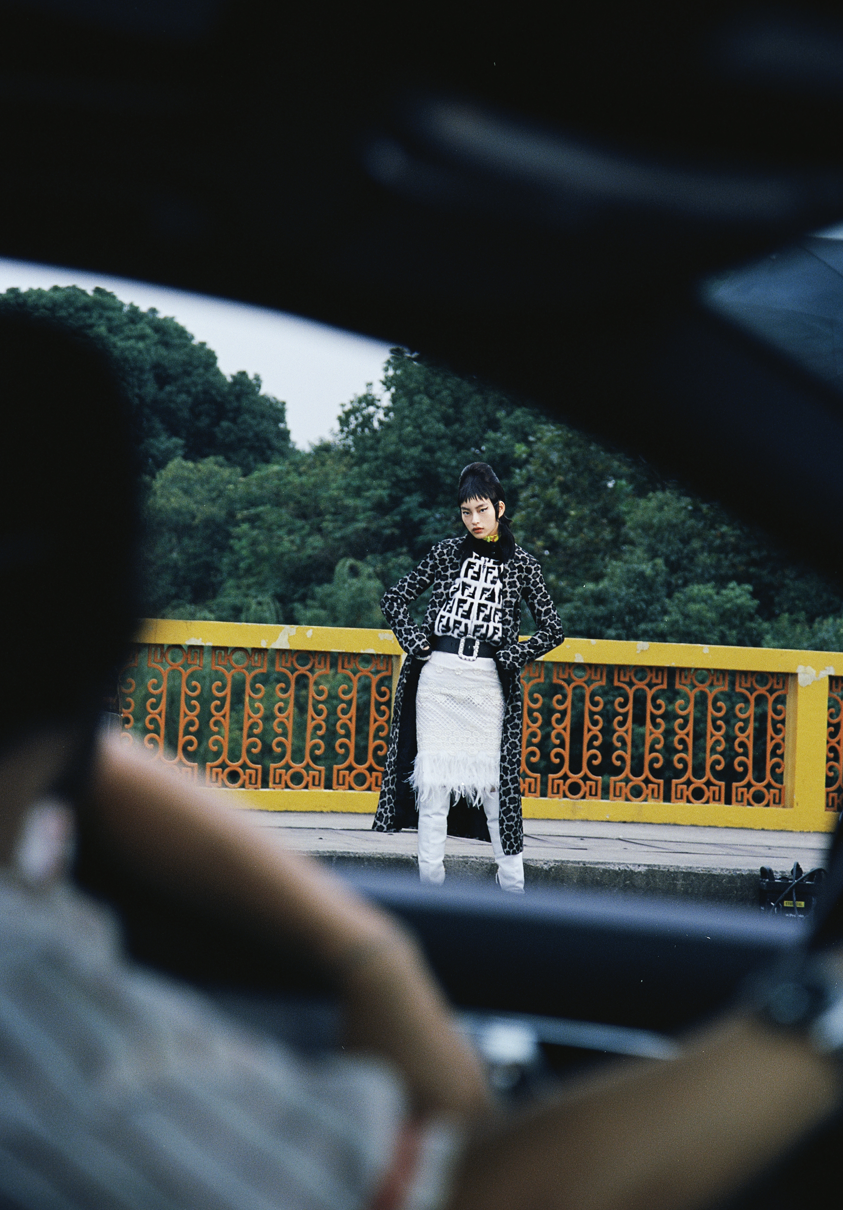 Grey leopard-print coat by Michael Kors; Black and white monogram fur jacket by Fendi; Black belt with pearls by Claudie Pierlot; White lace skirt with feather trim by Shiatzy Chen; White leather boots by Roberto Cavalli