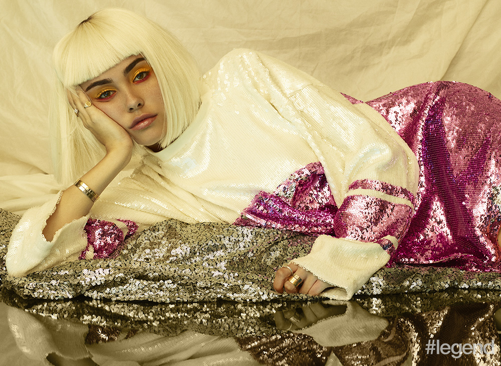 Ivory and pink sequinned sweater by Joyrich; love bangles in 18K white and yellow gold by Cartier 