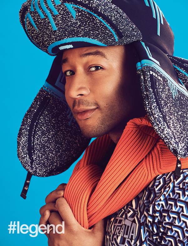 Blue trapper hat, orange sweater, blue printed polo by Prada