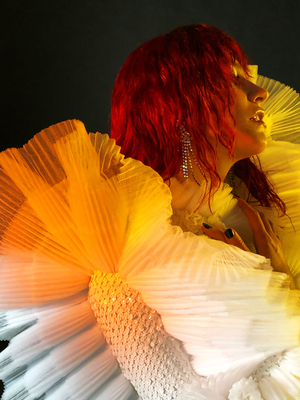 Pixie wears a white pleated gown by Viktor & Rolf Haute Couture