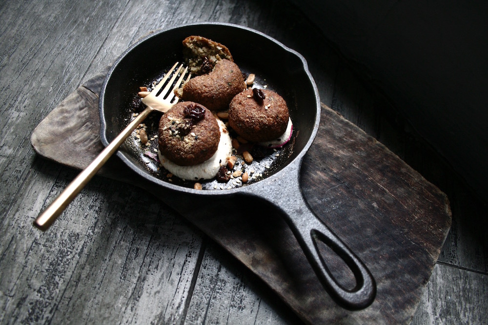 The lotus root kofta is served with a fresh tahini dressing made with toasted pine nuts, sweet spice plumped raisins and flax seed dukkah