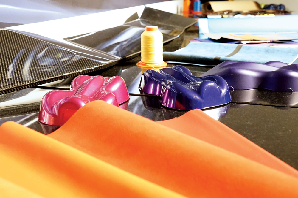 the tools of the trade to make a Lamborghini include custom leather and carbon fibre parts