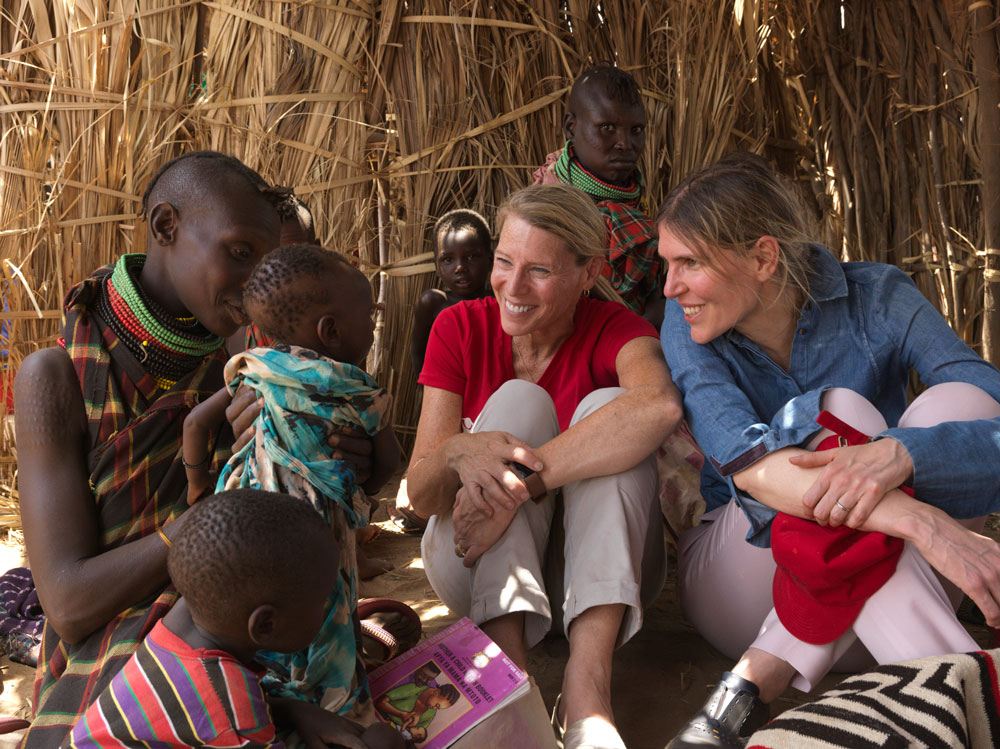 Designer Gabriela Hearst and Save the Children President & CEO Carolyn Miles meet with a woman and her family in Turkana County, Kenya, in July 2017 (photo by Peter Caton for Save the Children)