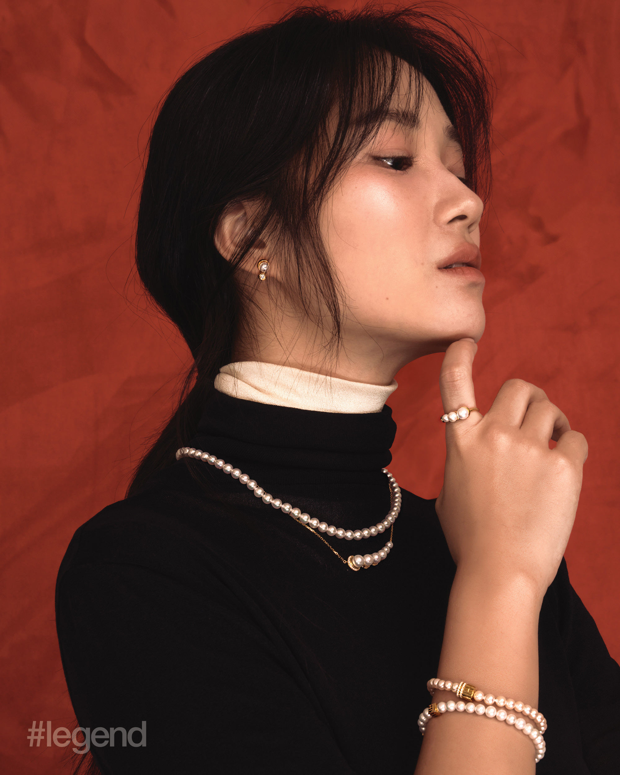 Black and white short-sleeve turtleneck _ Issey Miyake; Rouge Collection necklace and bracelets in 18k yellow gold with diamonds and pearls; and Luna series earrings, necklace and ring in 18k yellow gold with diamonds and pearls _ Chow Tai Fook