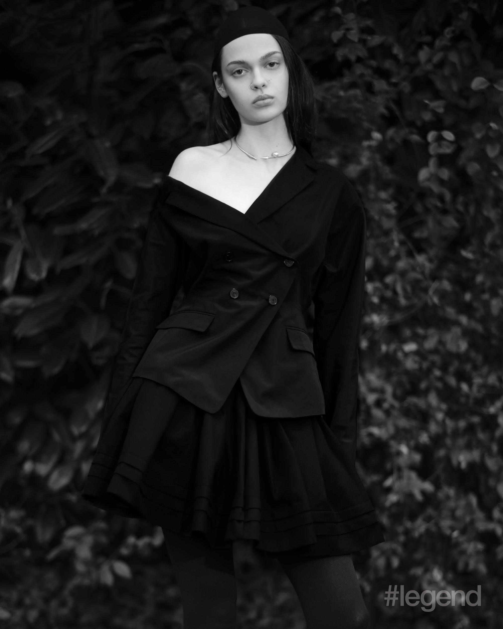 Black jacket _ Dior; Black pleated skirt _ Shushu/Tong; Black tights _ Wolford; Pearl necklace _ Dior